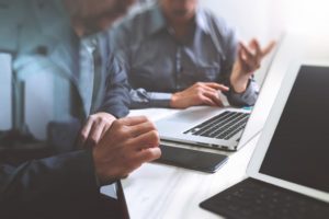 Businessmen using laptop